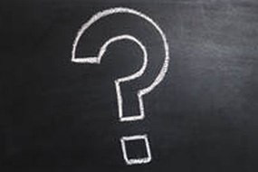 Chalk question mark on blackboard background.
