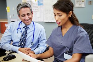 Doctor and nurse reviewing patient information together.
