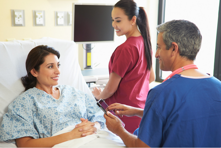 Patient with doctor and nurse in hospital.