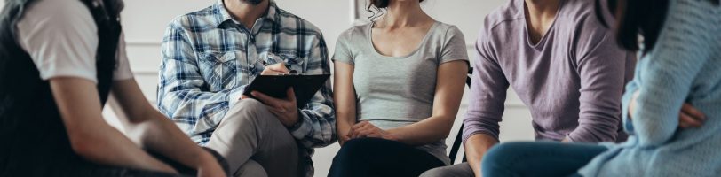 Group therapy session with seated participants. Group therapy session with seated participants.